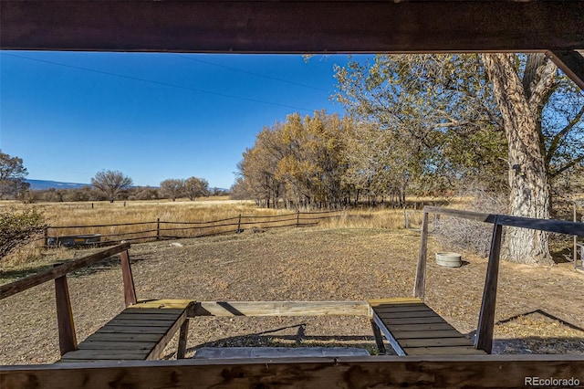 view of yard with a rural view