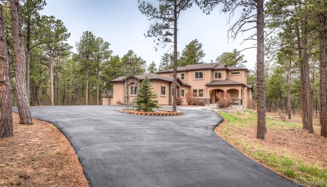 15948 Huckleberry Hts, Colorado Springs, CO 80908 - mediterranean / spanish home featuring stucco siding and driveway