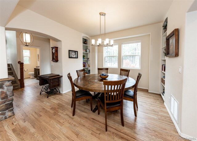 15948 Huckleberry Hts, Colorado Springs, CO 80908 - dining area featuring baseboards, an inviting chandelier, visible vents, and light wood-type flooring