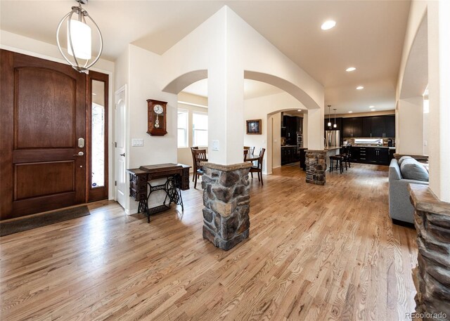 15948 Huckleberry Hts, Colorado Springs, CO 80908 - foyer entrance featuring arched walkways, recessed lighting, and light wood finished floors