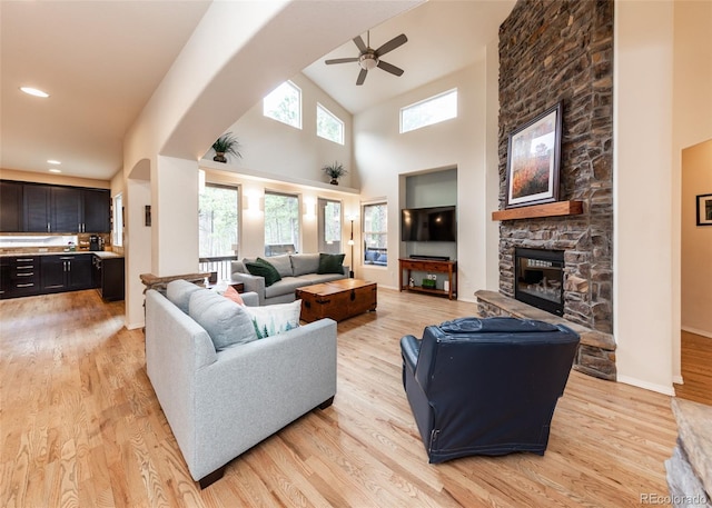 15948 Huckleberry Hts, Colorado Springs, CO 80908 - living room with light wood-style floors, high vaulted ceiling, ceiling fan, and a fireplace