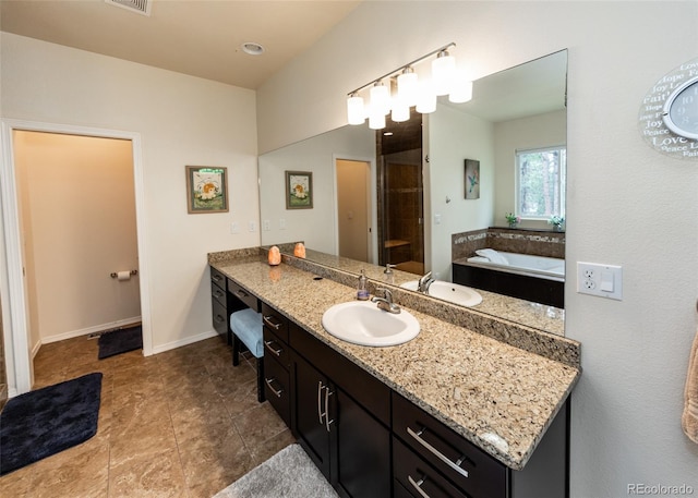 15948 Huckleberry Hts, Colorado Springs, CO 80908 - full bath featuring a garden tub, visible vents, a tile shower, vanity, and baseboards
