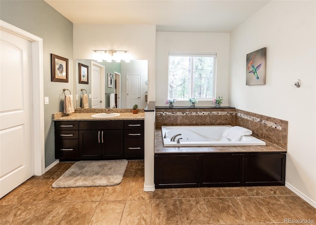 15948 Huckleberry Hts, Colorado Springs, CO 80908 - bathroom featuring tile patterned floors, baseboards, a bath, and vanity
