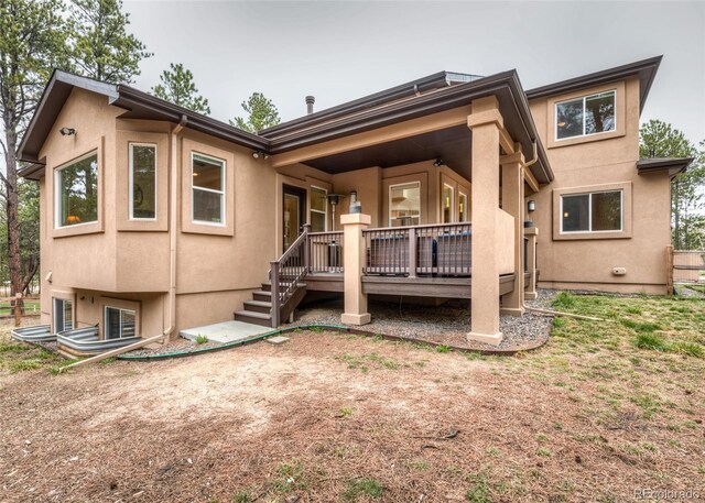 15948 Huckleberry Hts, Colorado Springs, CO 80908 - rear view of house with a wooden deck and stucco siding