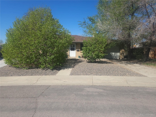 obstructed view of property featuring an attached garage and stucco siding