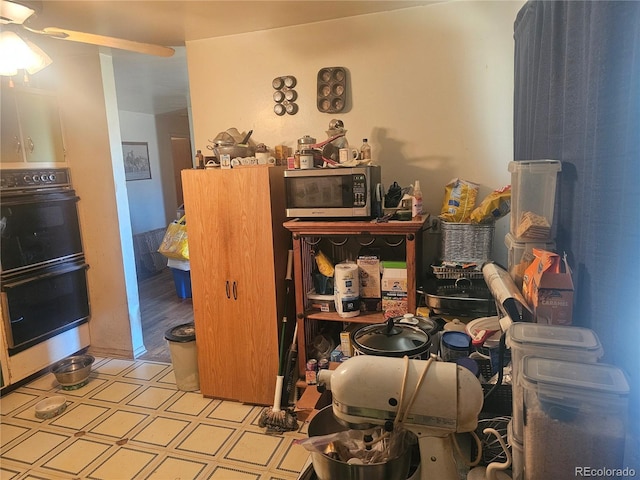 misc room with tile patterned floors and a ceiling fan