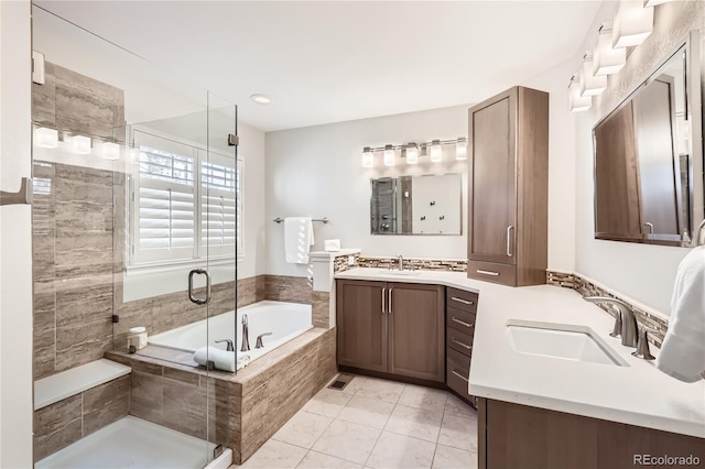 bathroom featuring tile patterned floors, separate shower and tub, and vanity