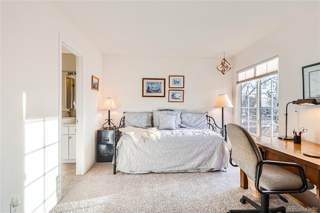 carpeted bedroom with connected bathroom