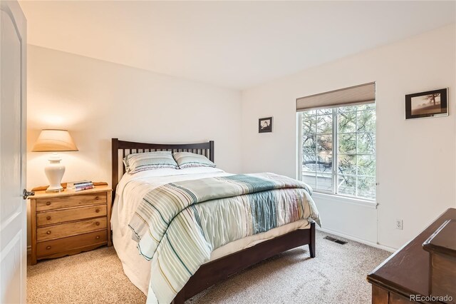 bedroom with light colored carpet