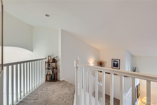 hall with carpet and lofted ceiling