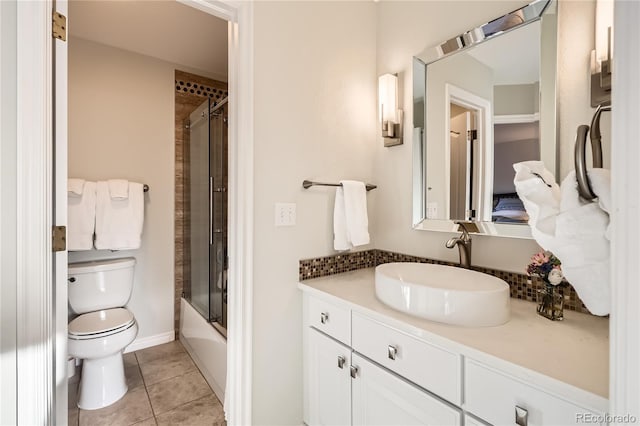 full bathroom with toilet, vanity, tile patterned floors, and combined bath / shower with glass door