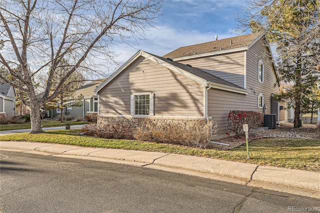 view of side of home with a lawn