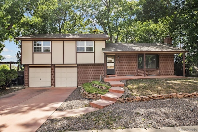 4631 Ashfield Dr, Boulder, CO 80301 - tri-level home featuring brick siding, driveway, a garage, a chimney, and a shingled roof
