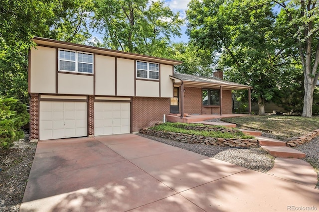4631 Ashfield Dr, Boulder, CO 80301 - view of front of property with brick siding, an attached garage, a chimney, and driveway