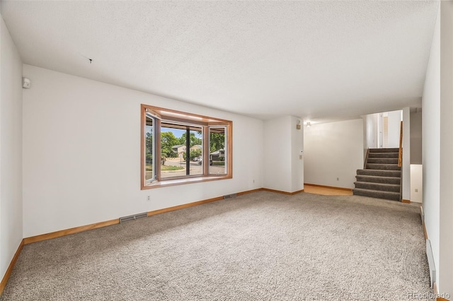 4631 Ashfield Dr, Boulder, CO 80301 - carpeted empty room featuring stairs and a textured ceiling