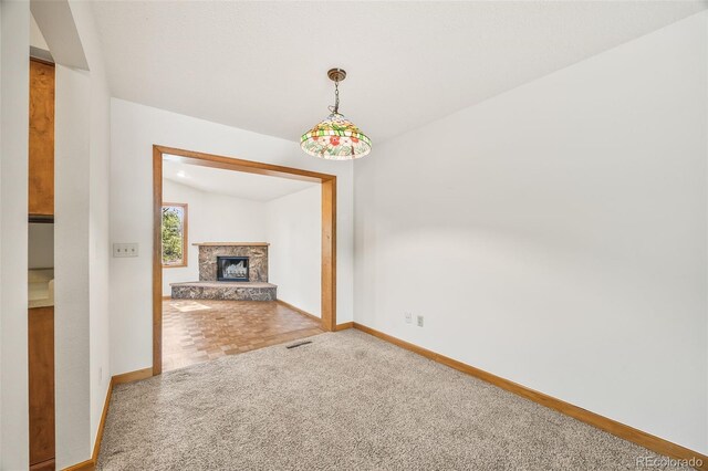 4631 Ashfield Dr, Boulder, CO 80301 - unfurnished living room with carpet floors and a fireplace with raised hearth