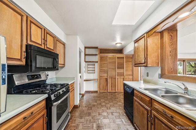 4631 Ashfield Dr, Boulder, CO 80301 - kitchen featuring black appliances, light countertops, brown cabinetry, and a skylight