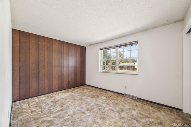 4631 Ashfield Dr, Boulder, CO 80301 - carpeted spare room featuring wood walls and a textured ceiling