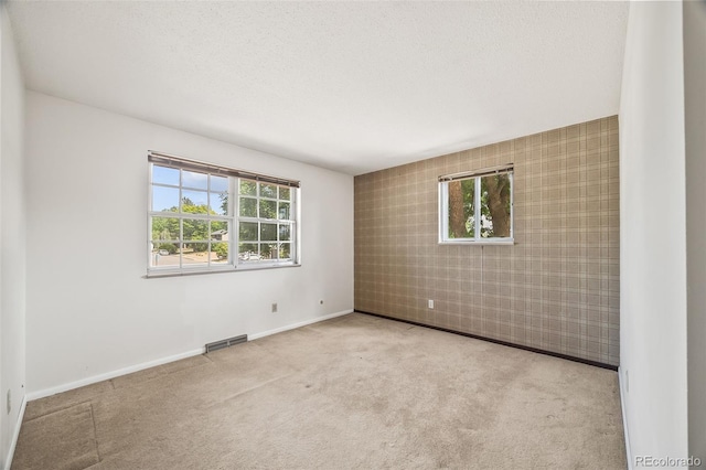4631 Ashfield Dr, Boulder, CO 80301 - carpeted spare room featuring an accent wall and a textured ceiling