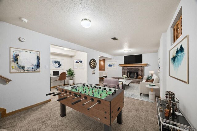 4631 Ashfield Dr, Boulder, CO 80301 - rec room featuring a fireplace, a textured ceiling, and carpet