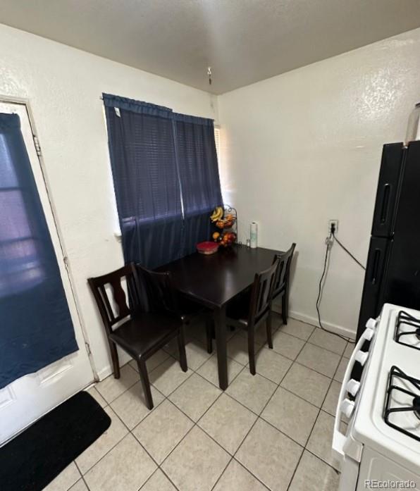 dining space featuring light tile floors