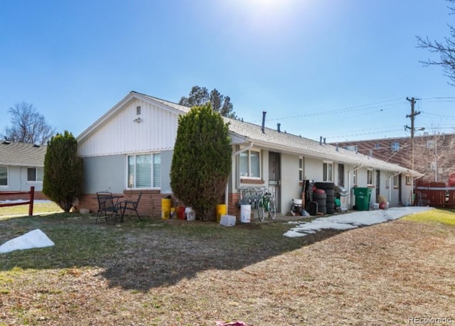 back of house with a lawn