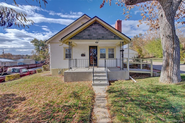 bungalow-style house featuring a porch and a front yard