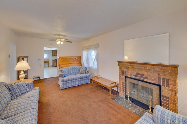 living room featuring carpet, ceiling fan, and a fireplace