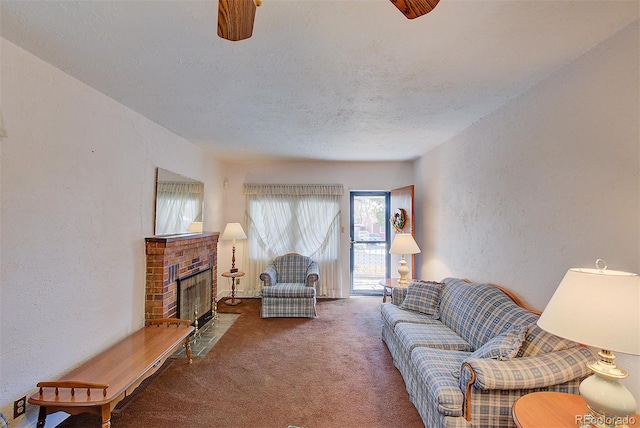 living room with carpet flooring, ceiling fan, a textured ceiling, and a brick fireplace