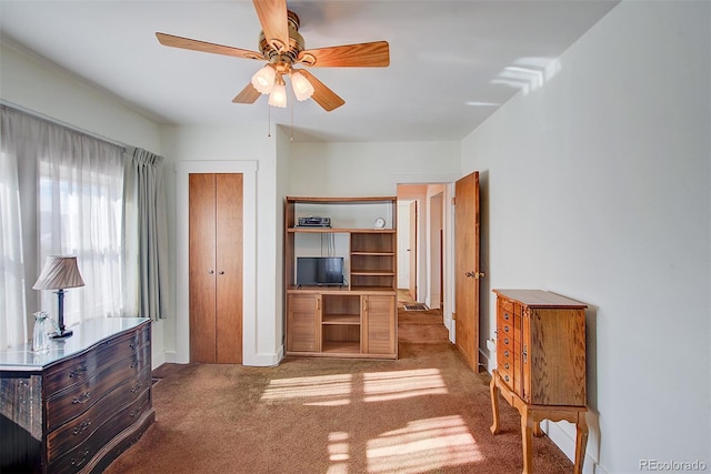 bedroom featuring carpet flooring, ceiling fan, and a closet