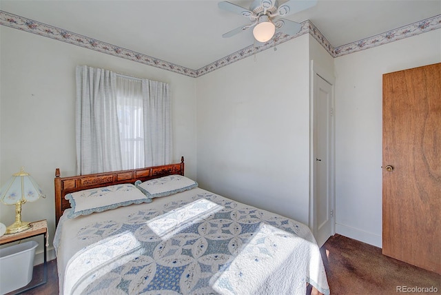 bedroom with dark colored carpet and ceiling fan