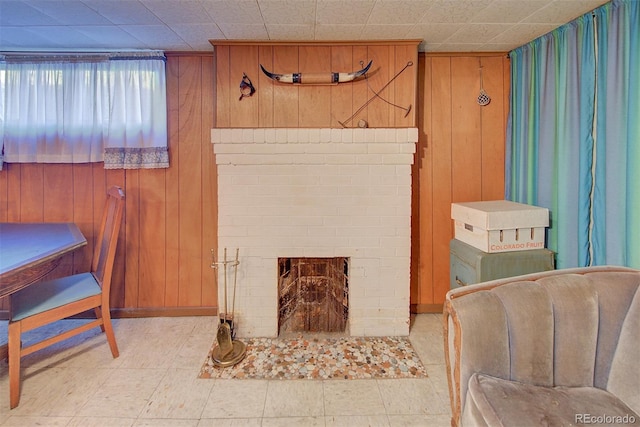 bathroom with wood walls and a fireplace