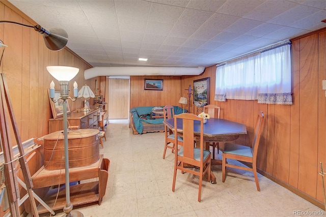 dining room with wooden walls