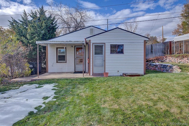 view of front of property featuring a front lawn and a patio area