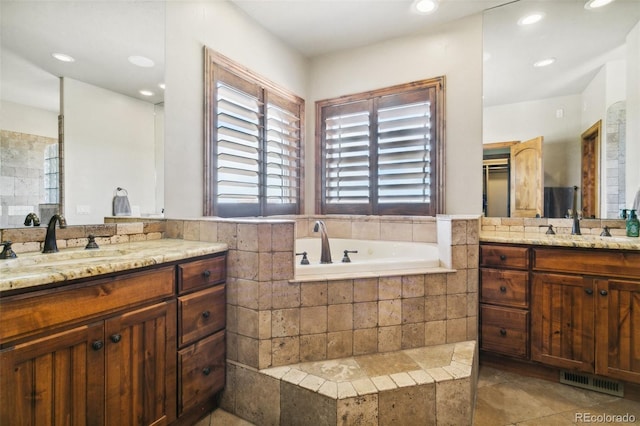 7830 Tannenbaum Rd, Colorado Springs, CO 80908 - full bathroom featuring two vanities, a bath, and recessed lighting
