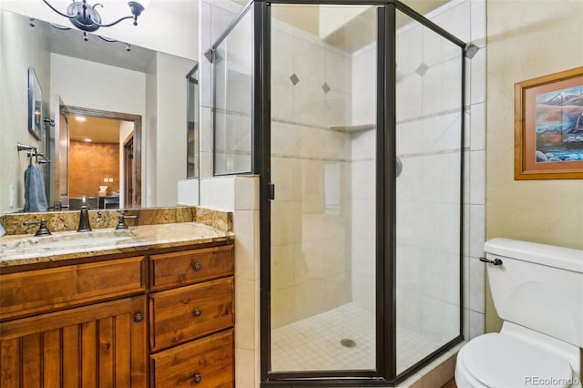 7830 Tannenbaum Rd, Colorado Springs, CO 80908 - bathroom with toilet, vanity, and a shower stall