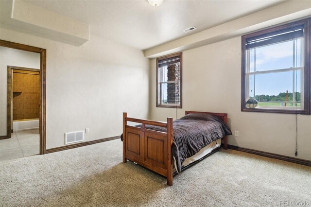 7830 Tannenbaum Rd, Colorado Springs, CO 80908 - bedroom featuring light colored carpet, multiple windows, and baseboards
