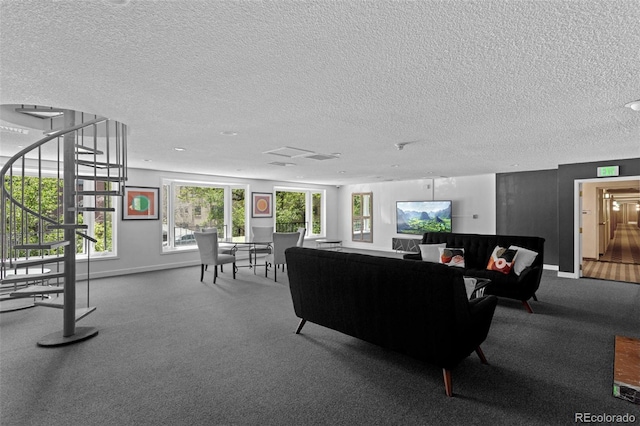 555 E 10th Ave Unit 15, Denver, CO 80203 - living room with a textured ceiling, baseboards, carpet floors, and stairway
