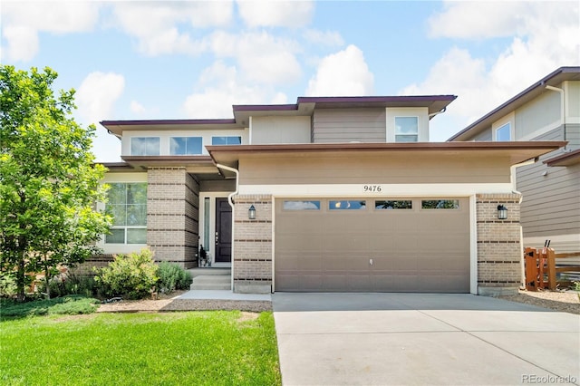 9476 Juniper Way, Arvada, CO 80007 - prairie-style home featuring brick siding, driveway, and an attached garage