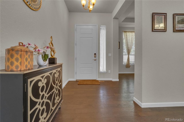 9476 Juniper Way, Arvada, CO 80007 - entrance foyer with dark wood-style flooring and a chandelier