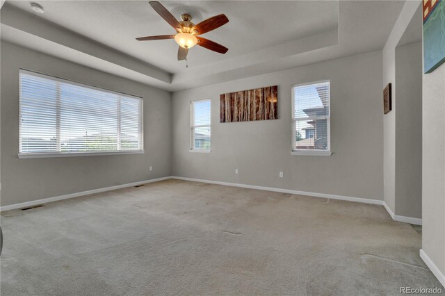 9476 Juniper Way, Arvada, CO 80007 - spare room with a tray ceiling, a smoke detector, ceiling fan, and light colored carpet