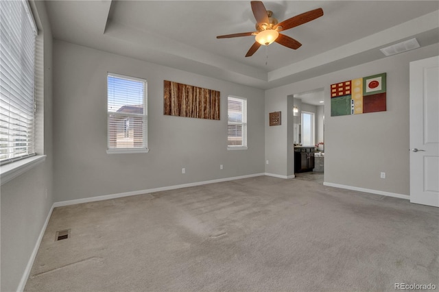 9476 Juniper Way, Arvada, CO 80007 - unfurnished room with a ceiling fan, light colored carpet, and a raised ceiling