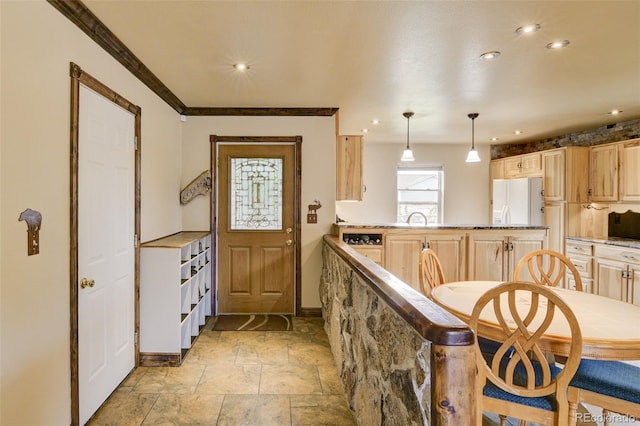 130 Windwalker Rd, Buena Vista, CO 81211 - kitchen with freestanding refrigerator, light brown cabinets, a peninsula, stone tile flooring, and recessed lighting
