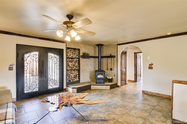 130 Windwalker Rd, Buena Vista, CO 81211 - entrance foyer with french doors, arched walkways, ceiling fan, a wood stove, and crown molding
