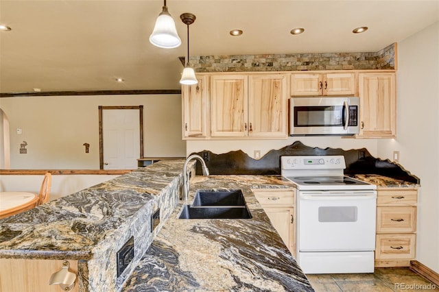 130 Windwalker Rd, Buena Vista, CO 81211 - kitchen with white range with electric cooktop, stainless steel microwave, light brown cabinets, dark stone countertops, and recessed lighting