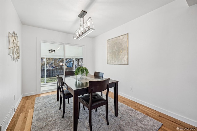 dining area with wood-type flooring