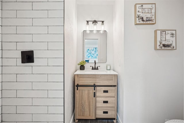 bathroom with vanity and a shower