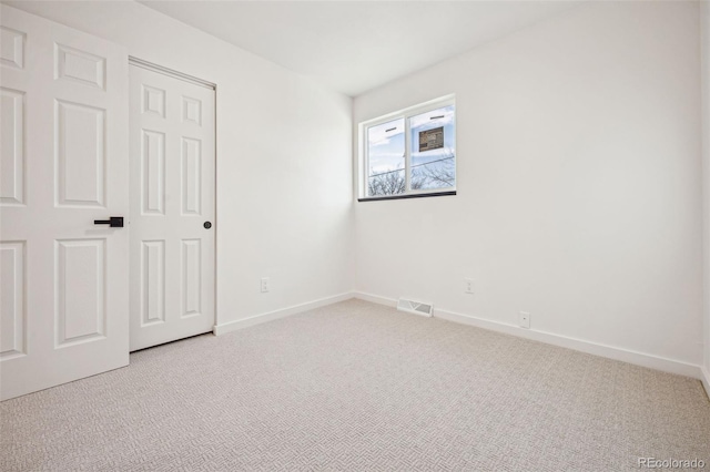 unfurnished bedroom featuring light carpet