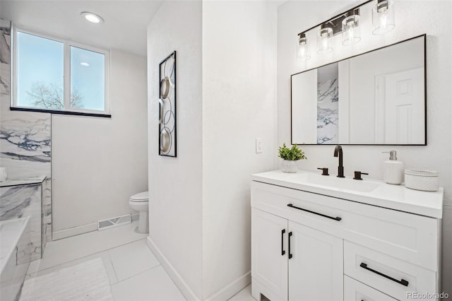 bathroom featuring vanity, tile patterned flooring, and toilet