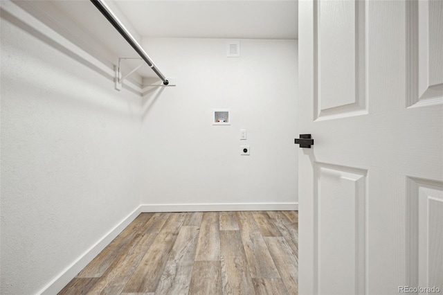 washroom featuring electric dryer hookup, washer hookup, and light hardwood / wood-style flooring